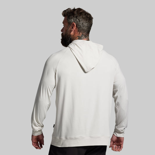 Man wearing a white hoodie against a gray background
