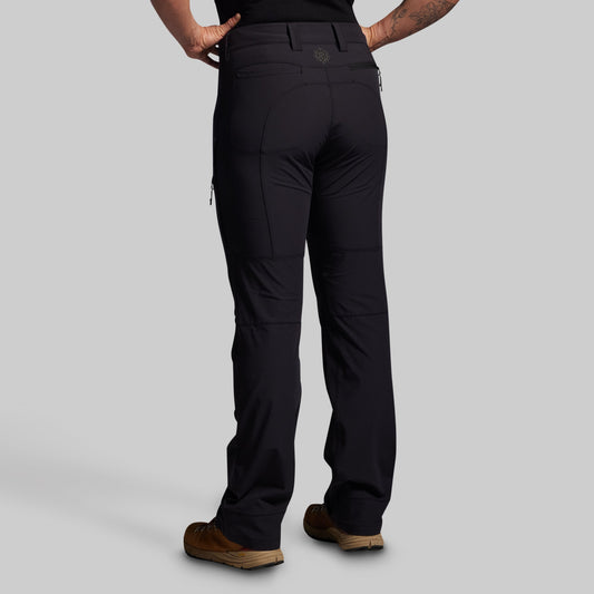 Black pants worn by a person on a gray background