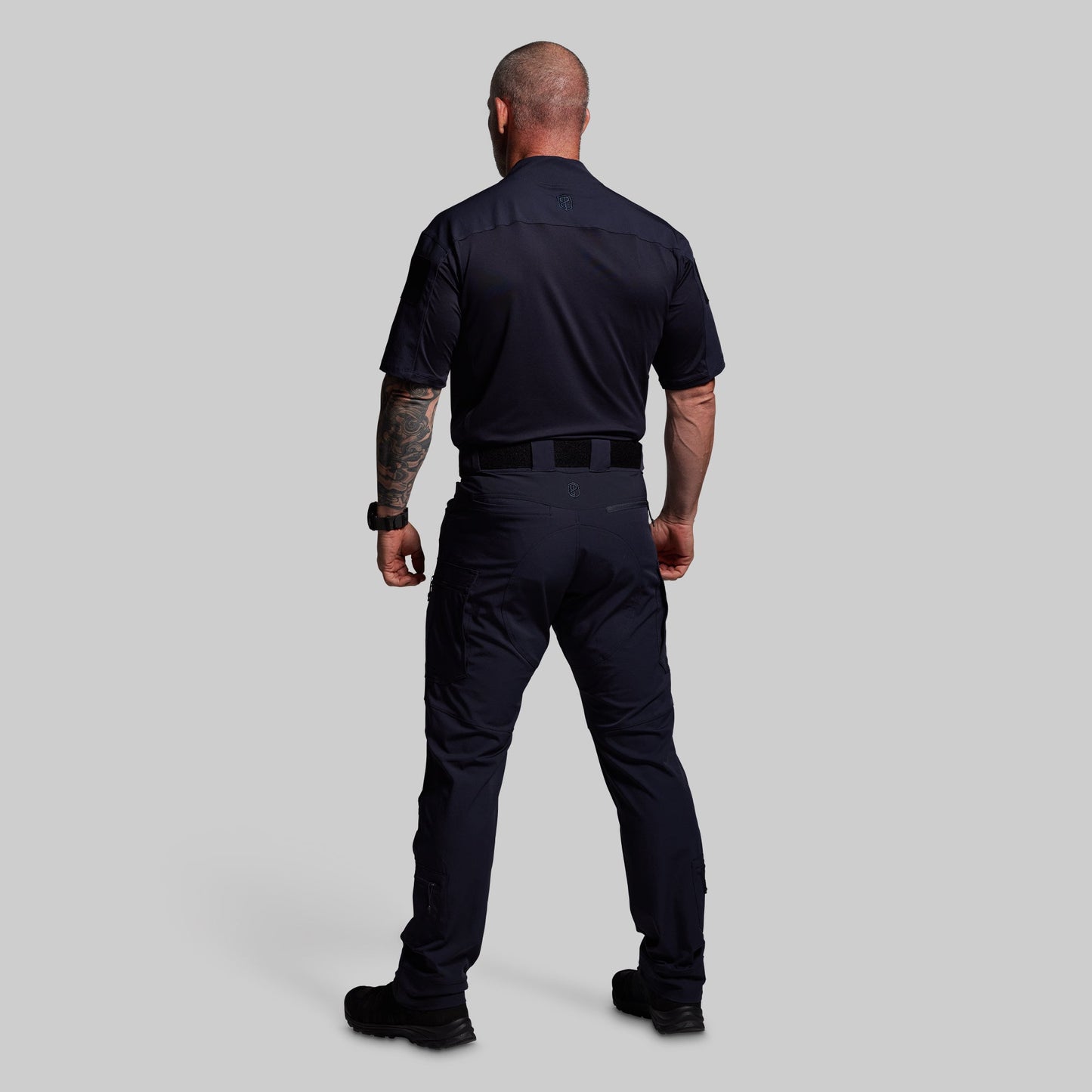 Person wearing a blue uniform on a gray background