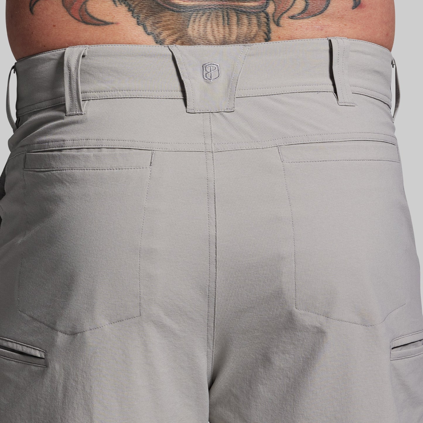 Gray shorts with a brand logo on a plain background