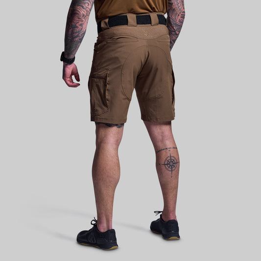 Person wearing brown tactical shorts on a light gray background