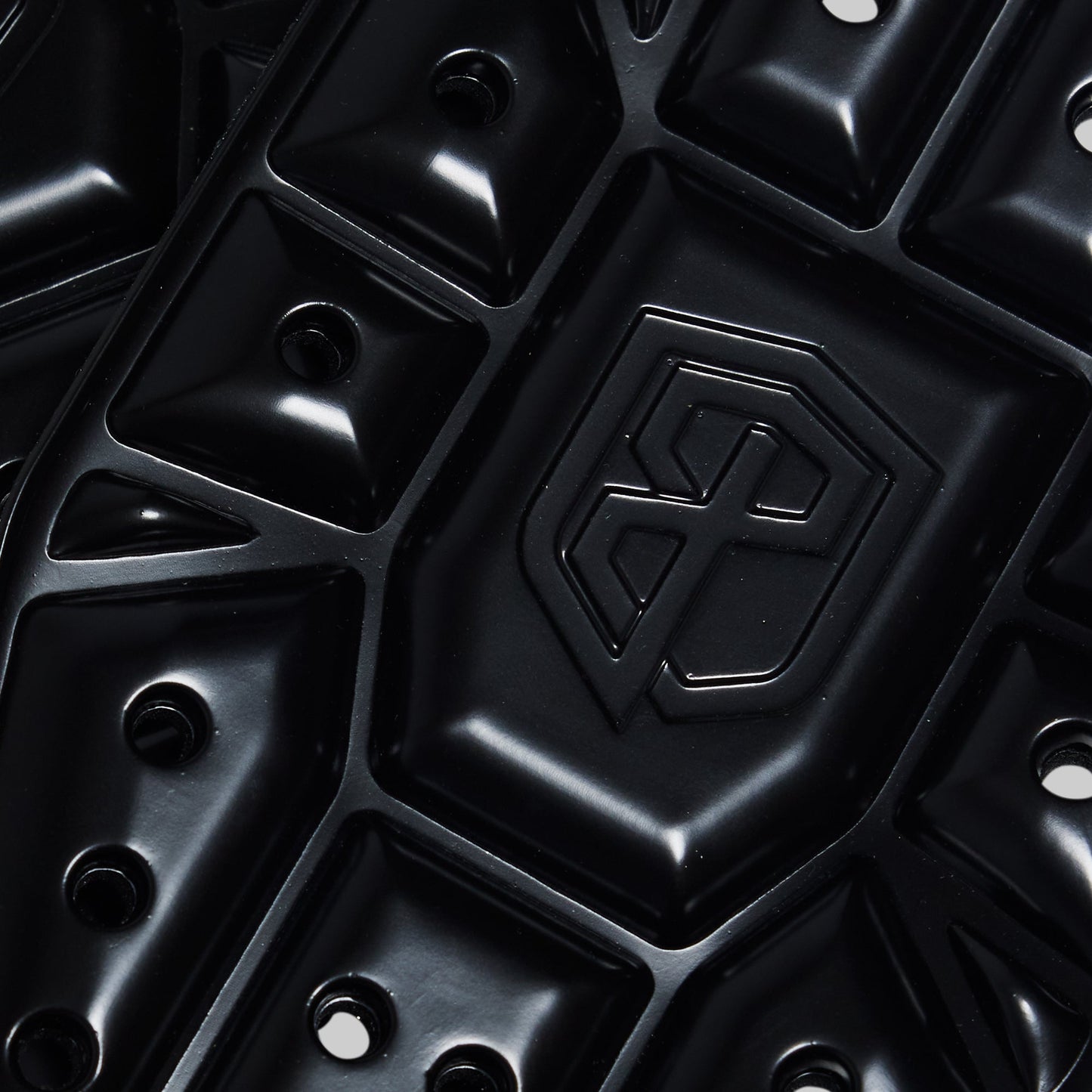 Close-up of a black knee pads with a brand logo.
