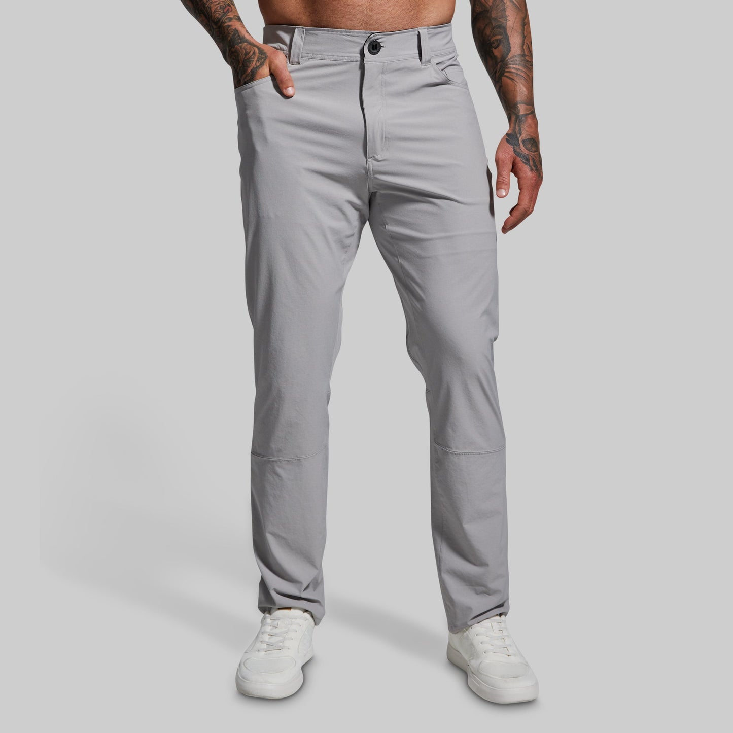 Person wearing gray pants on a plain background