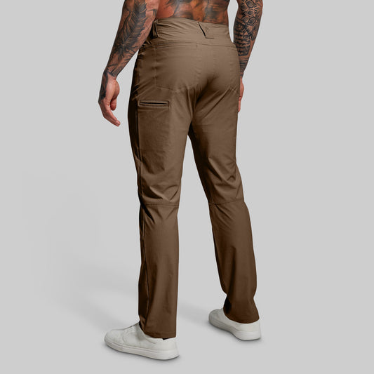 Brown pants worn by a person on a gray background