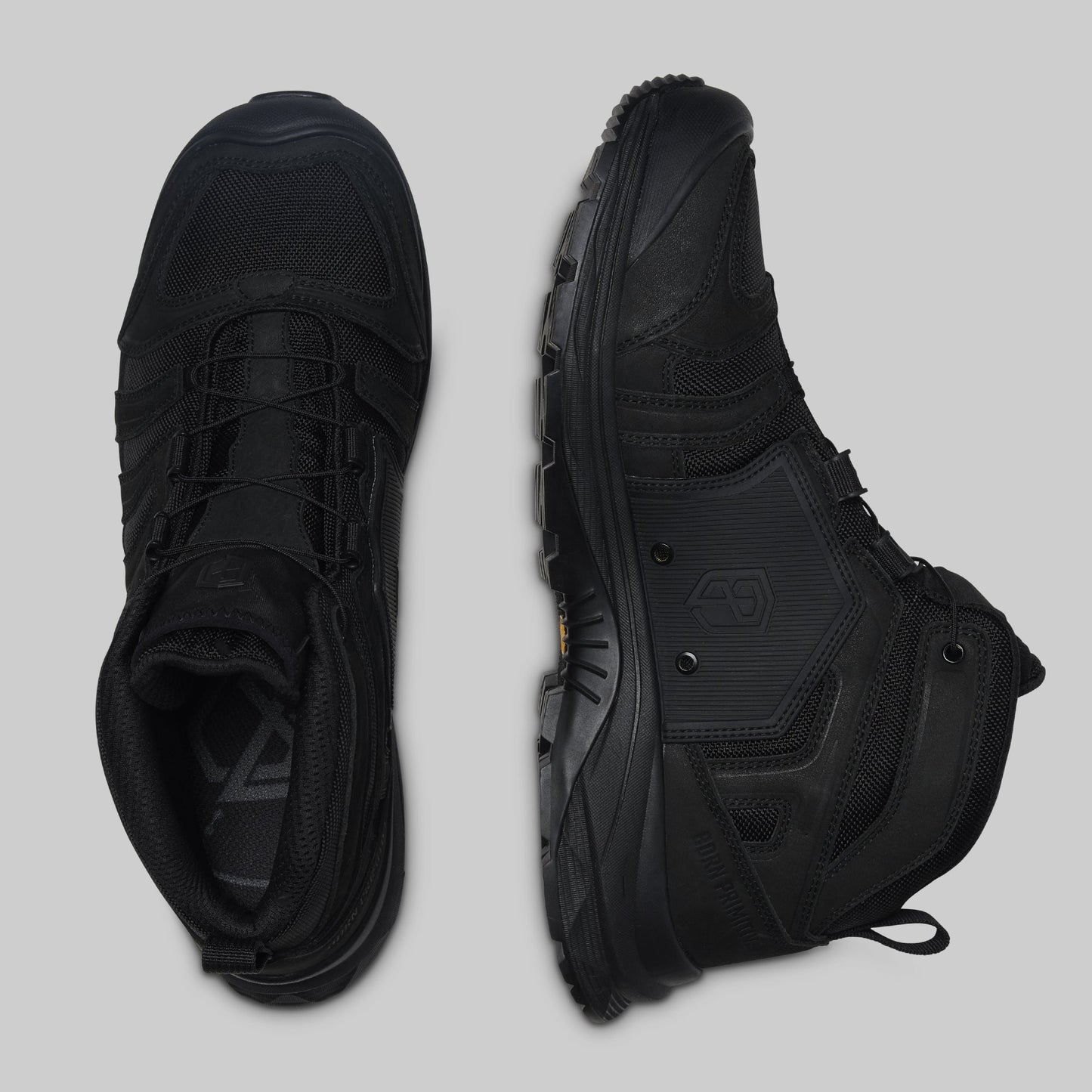 Pair of black boots on a light gray background