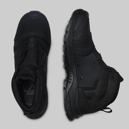 Pair of black boots on a light gray background
