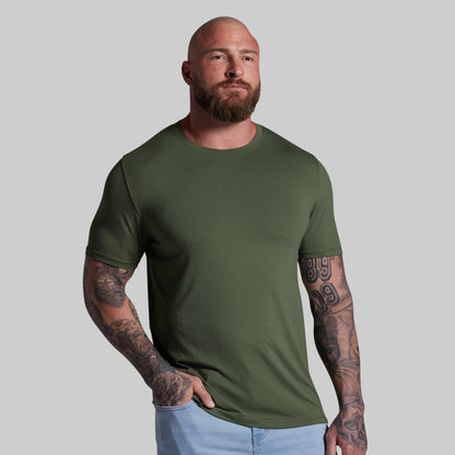 Man wearing a green t-shirt against a plain background
