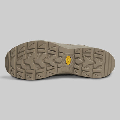 Close-up of a brown shoe sole with a textured pattern on a gray background