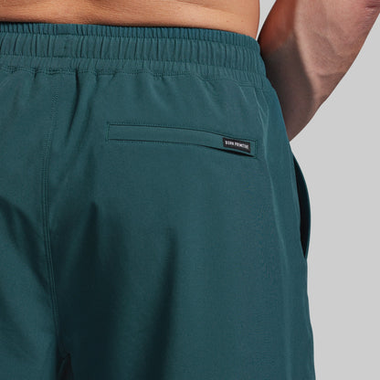 Teal shorts with a brand label on a gray background