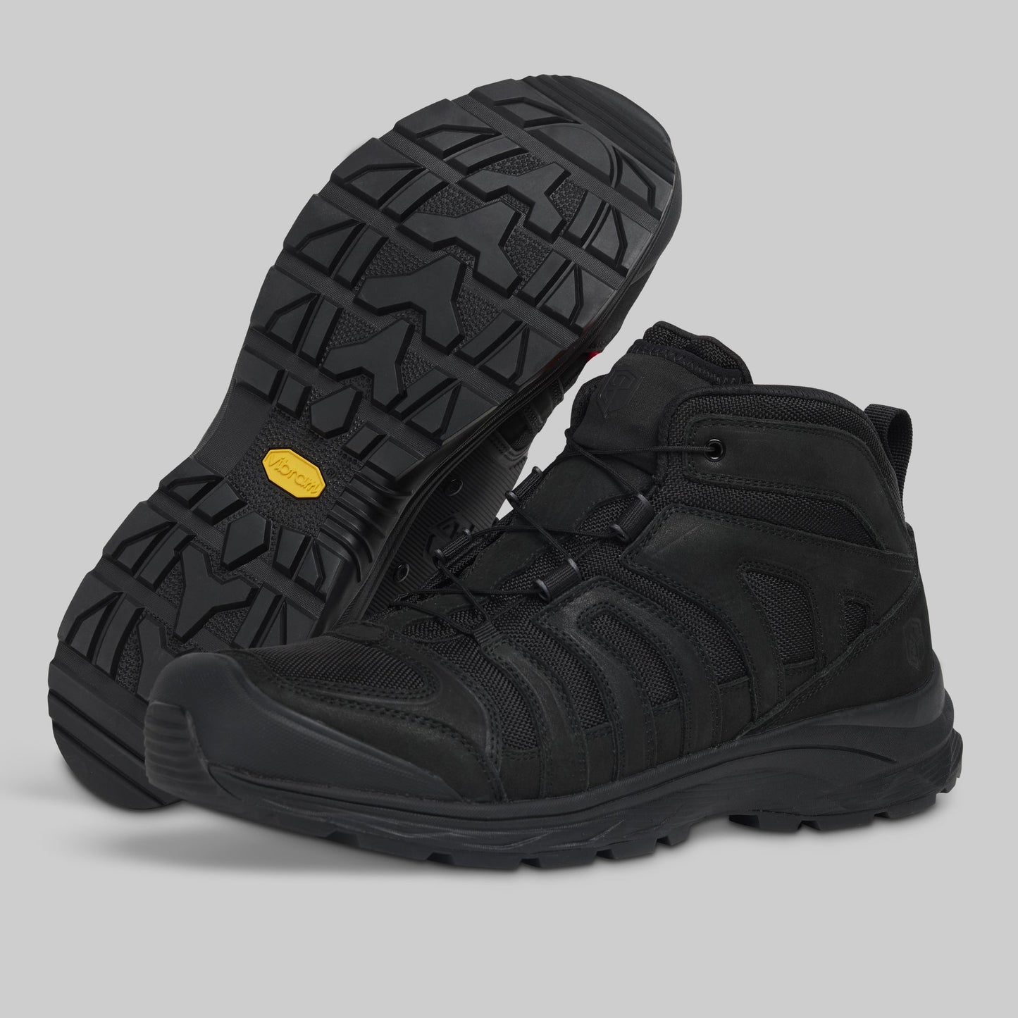 Black boots with a yellow label on a gray background