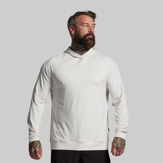 Man wearing a white hoodie against a gray background