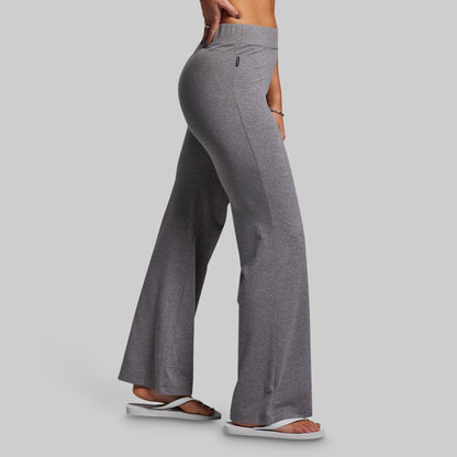 Gray flared pants worn by a person on a gray background