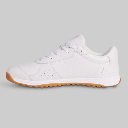 White sneaker with brown sole on a light gray background