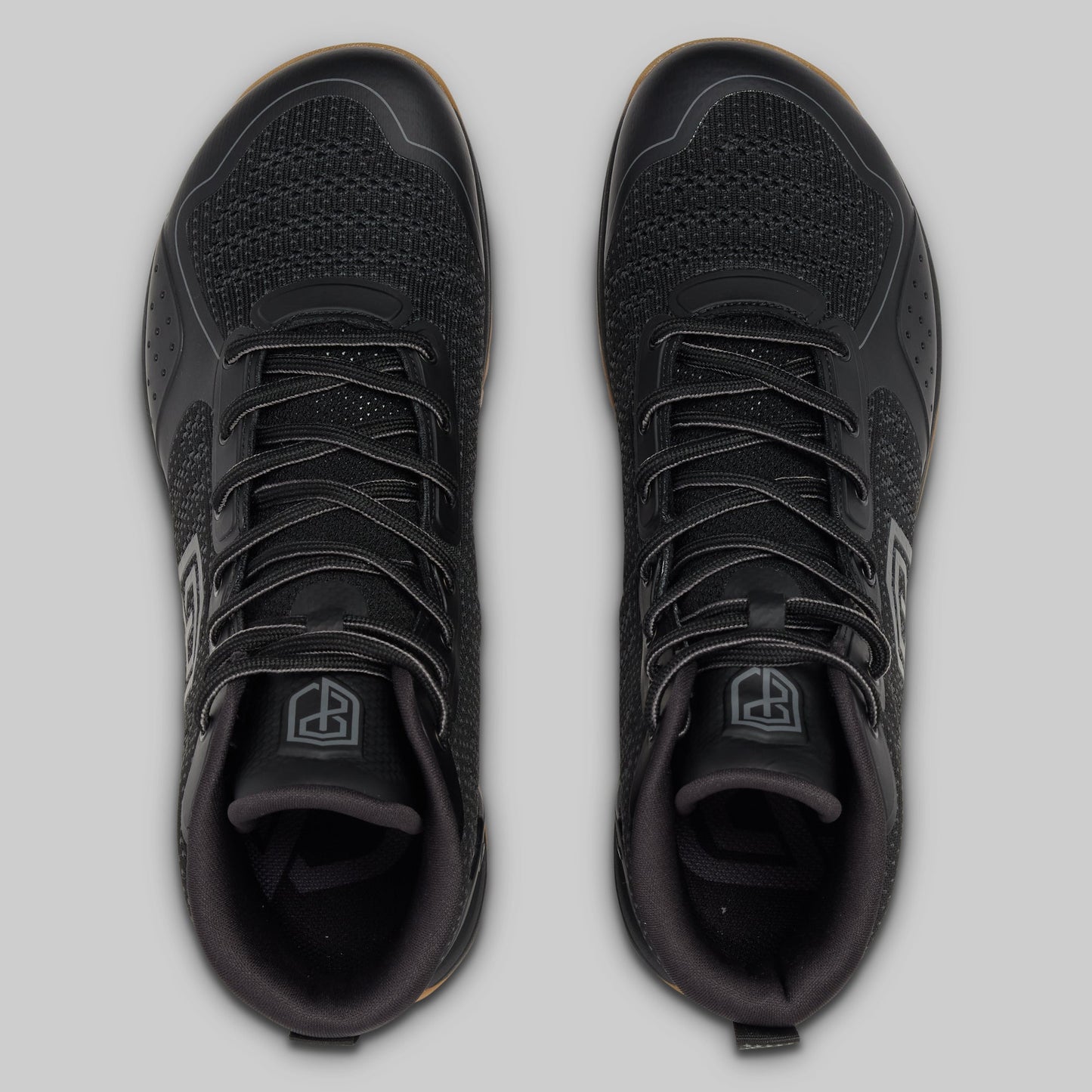 Black athletic shoes on a light gray background