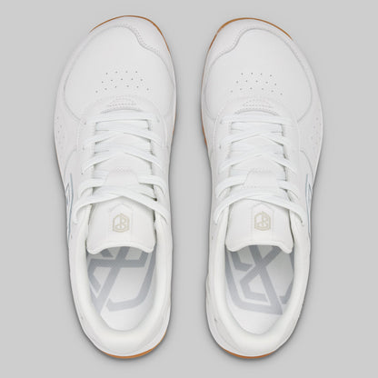 White sneakers with a brand logo on a gray background