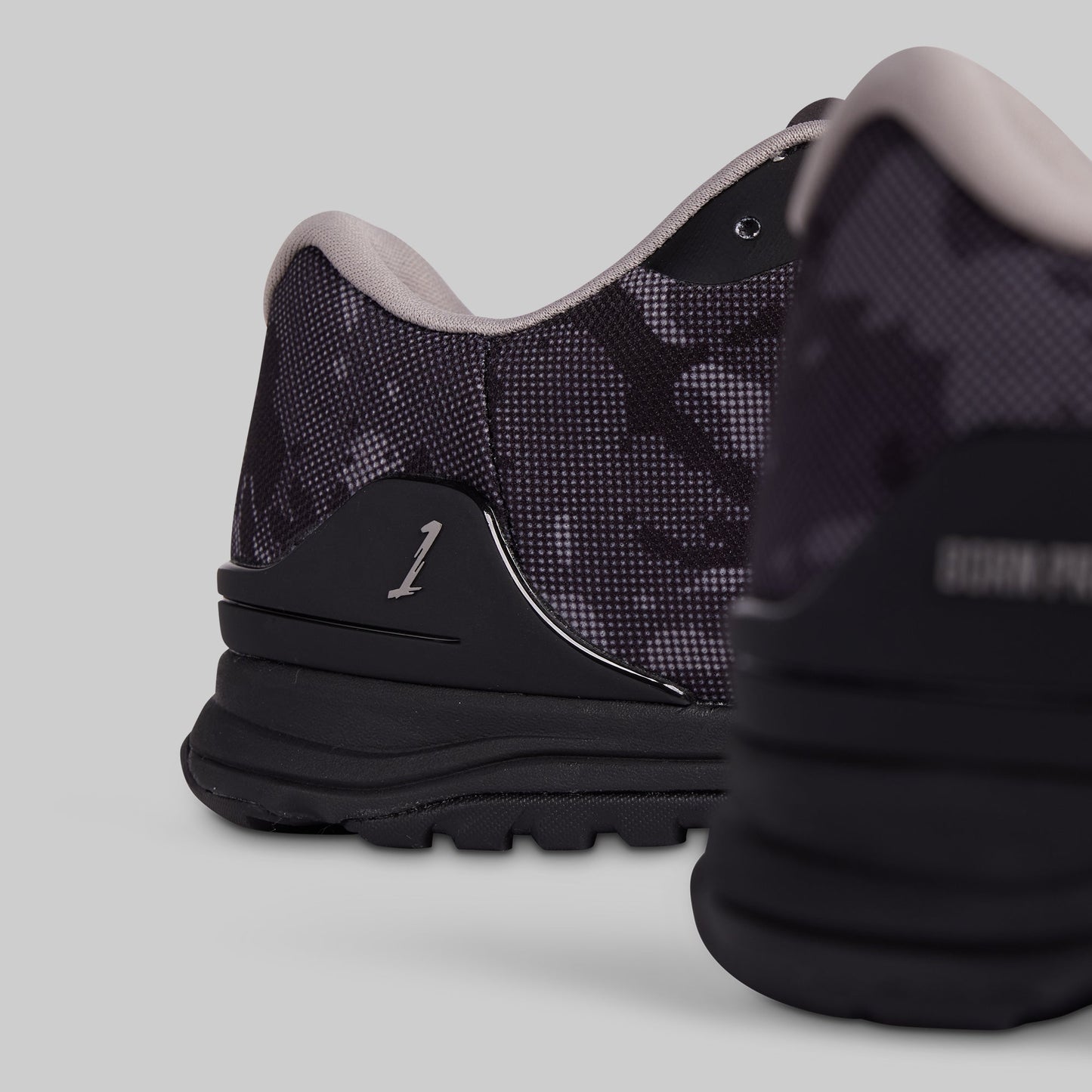 Black and gray sneaker on a light gray background