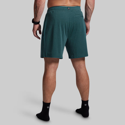 Person wearing teal shorts on a gray background