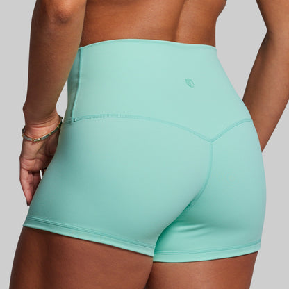 Teal athletic shorts worn by a person on a plain background