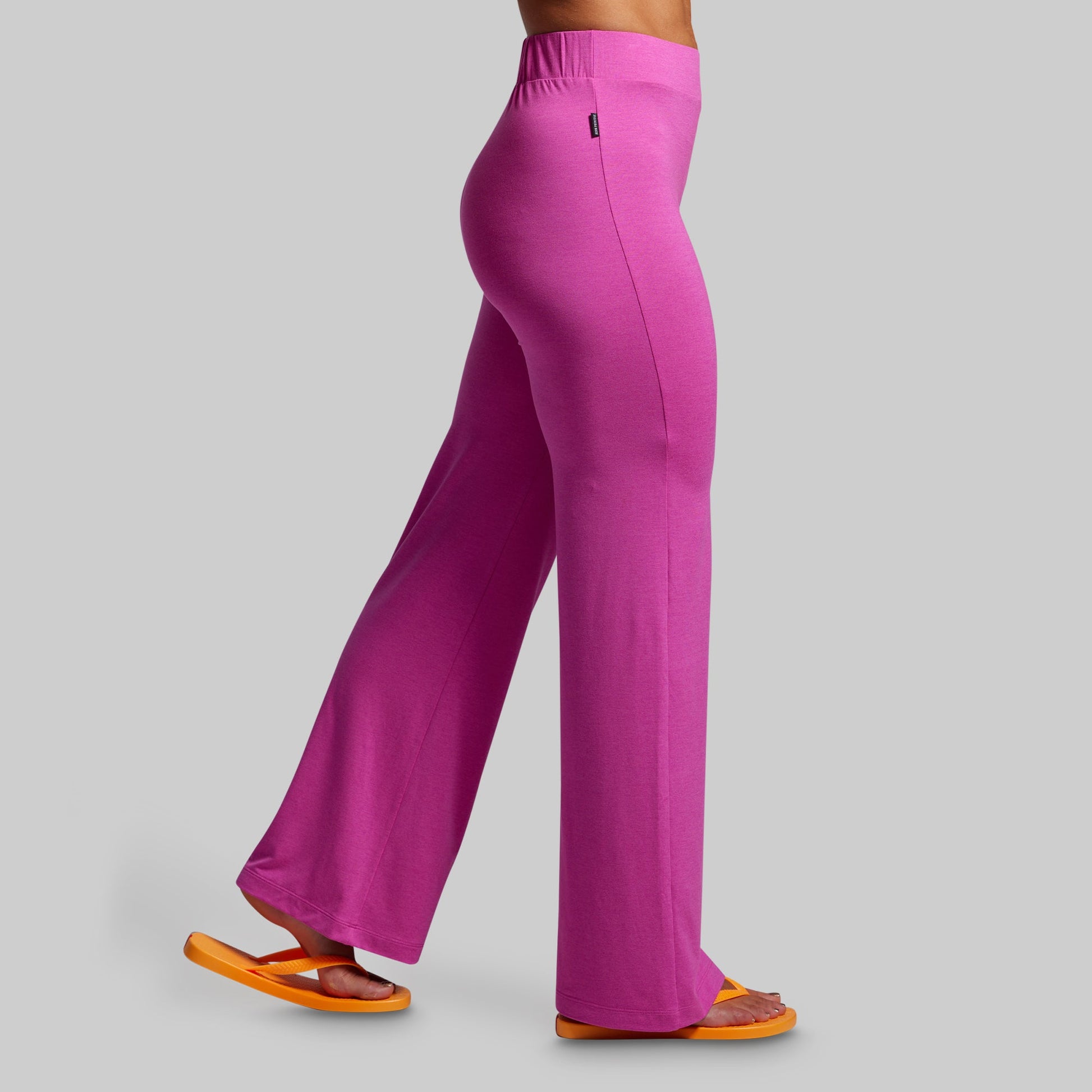 Pink pants worn by a person on a gray background