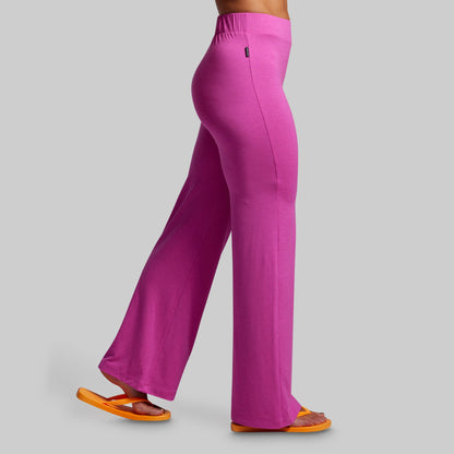 Pink pants worn by a person on a gray background