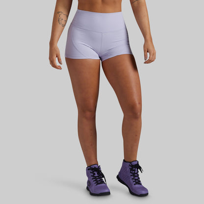 A model wearing light lavender high-waisted athletic shorts and purple hight top sneakers, shown from the waist down against a solid gray background.