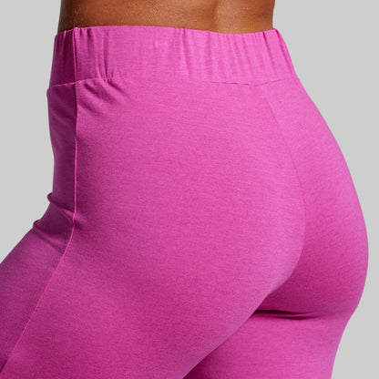 Close-up of bright pink leggings on a plain background