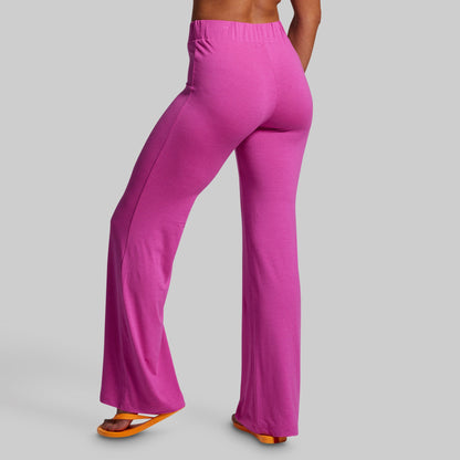 Purple pants worn by a person on a gray background