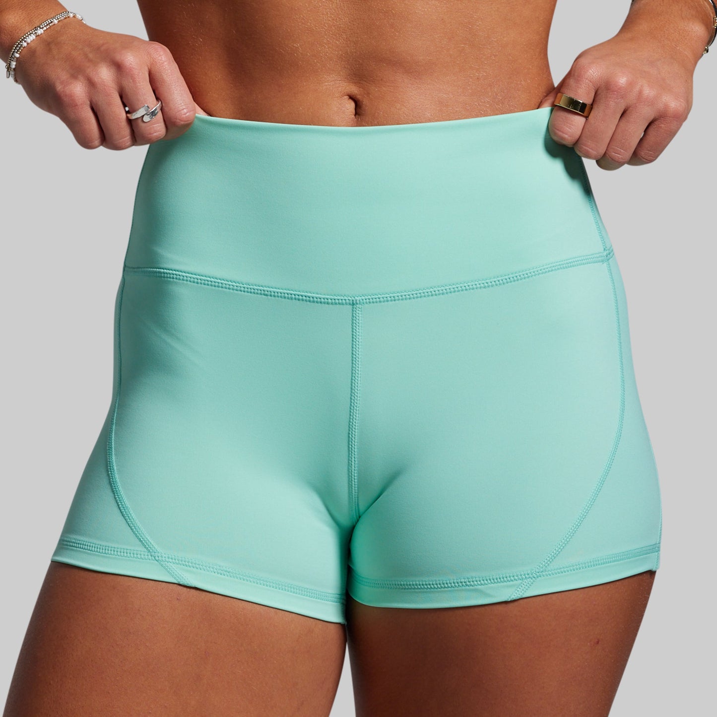 Teal athletic shorts worn by a person on a plain background
