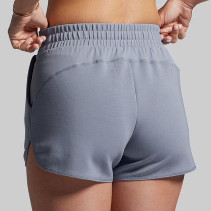 Gray lounge shorts worn by a person on a plain background