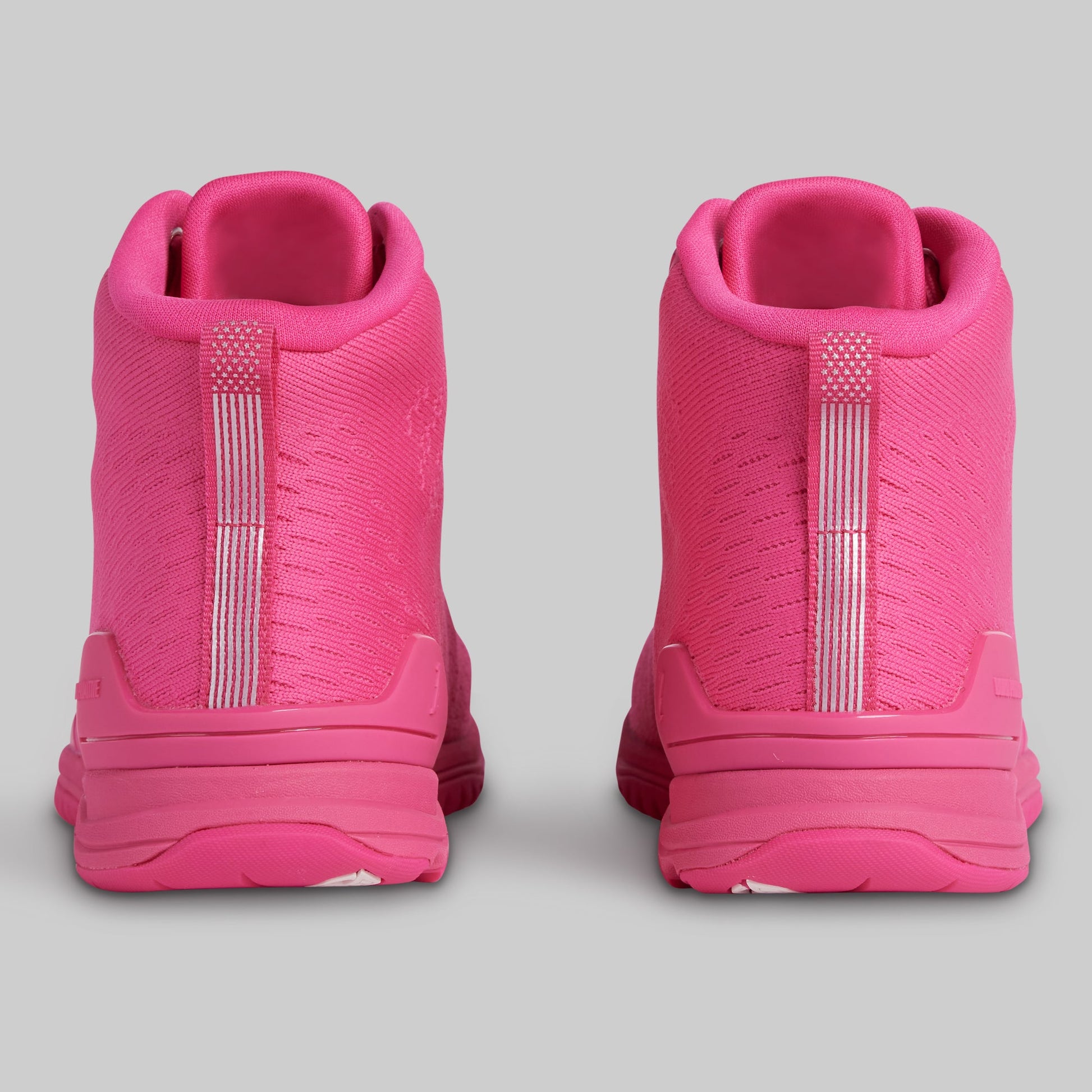 Pink high-top sneakers on a gray background