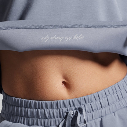 Person wearing a light gray outfit with text on the inside seam