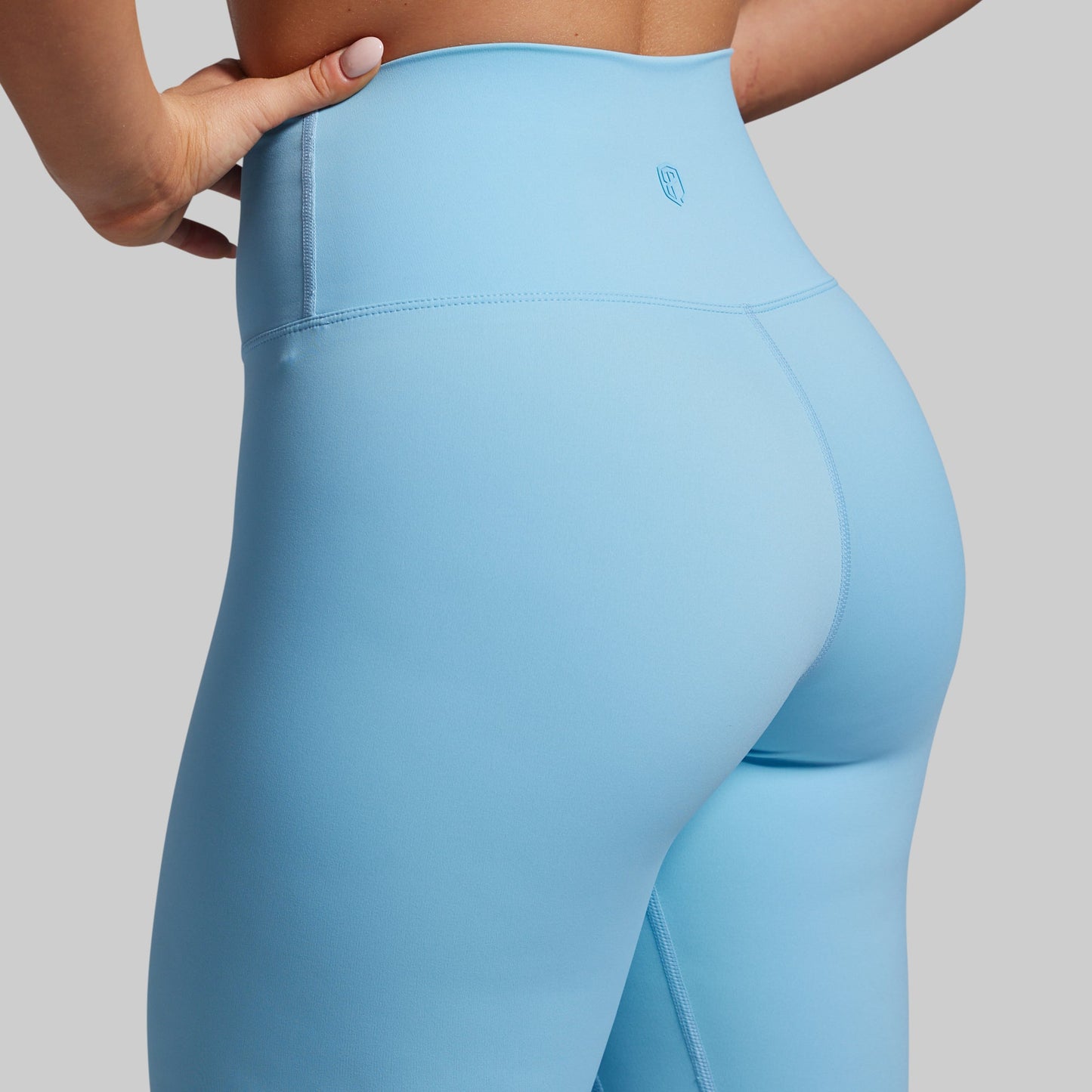 Light blue leggings worn by a person on a gray background