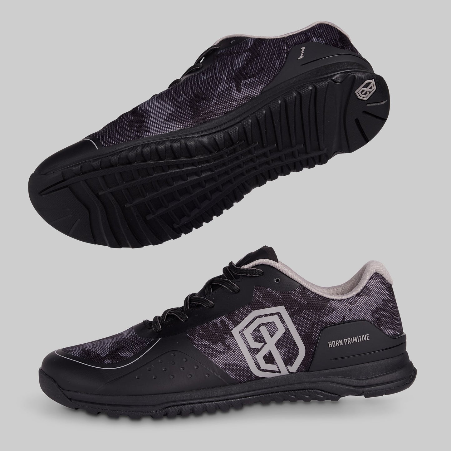 Black and grey camouflage athletic shoes with a visible brand logo on a gray background