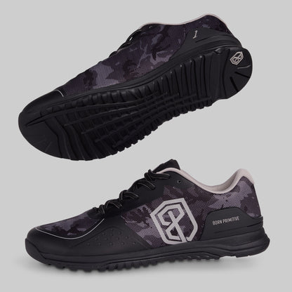 Black and grey camouflage athletic shoes with a visible brand logo on a gray background