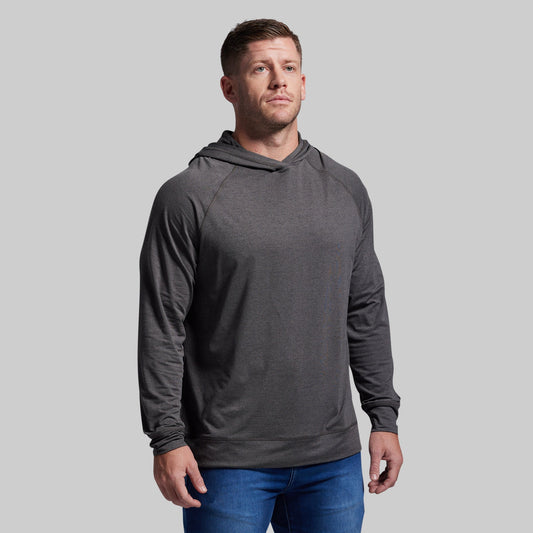 Man wearing a gray hoodie against a plain background