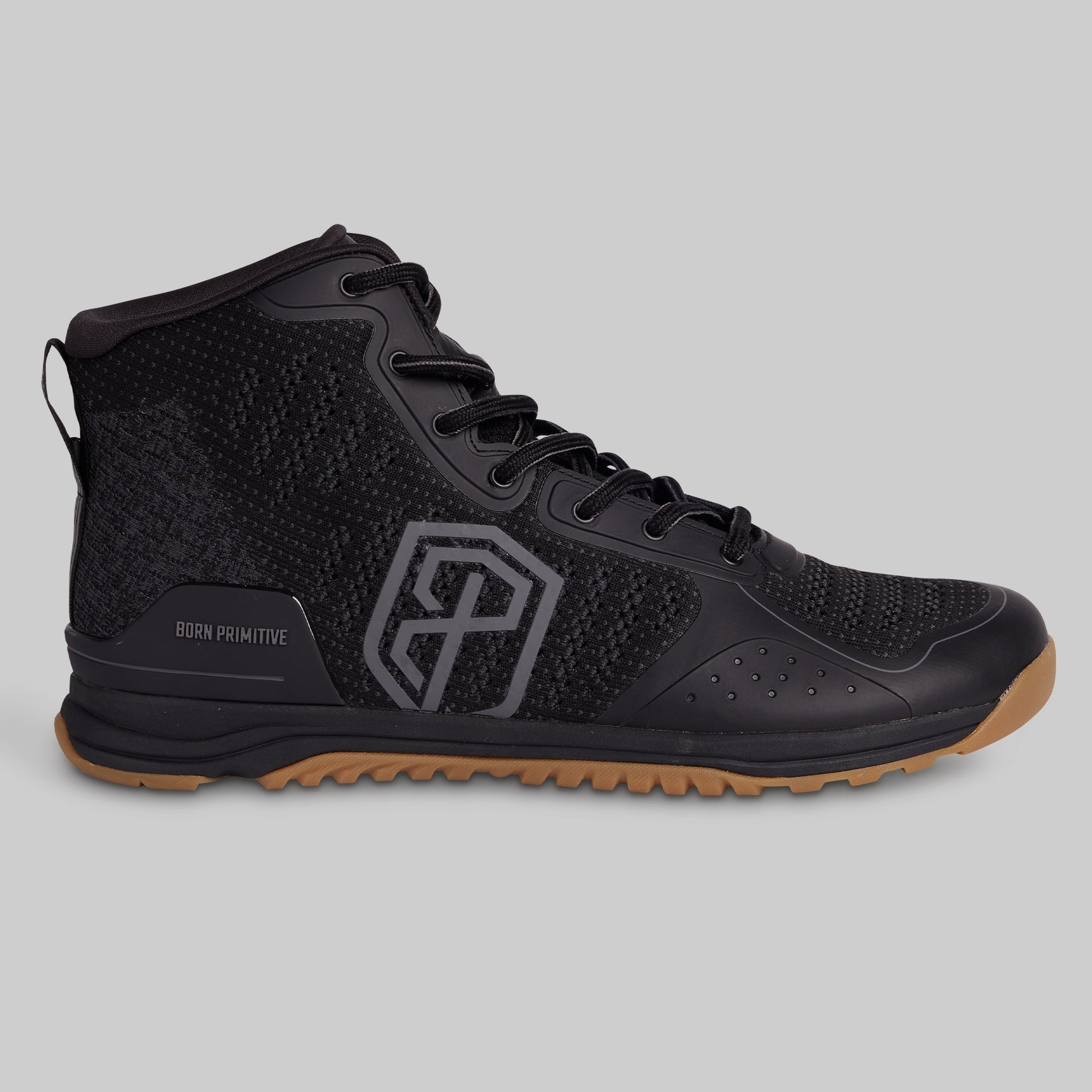 Black high-top sneaker with a brown sole on a gray background
