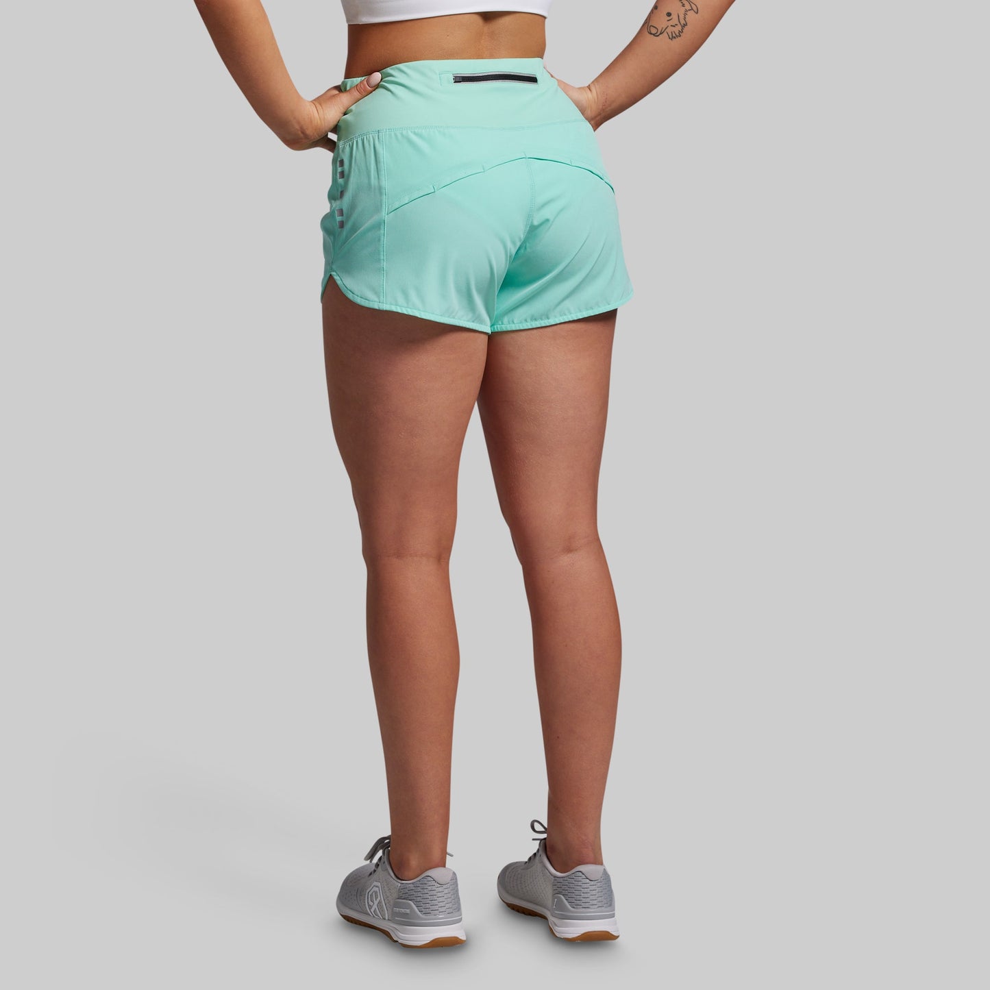 Person wearing light blue athletic shorts on a plain background