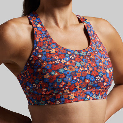 Multicolored floral sports bra on a neutral background