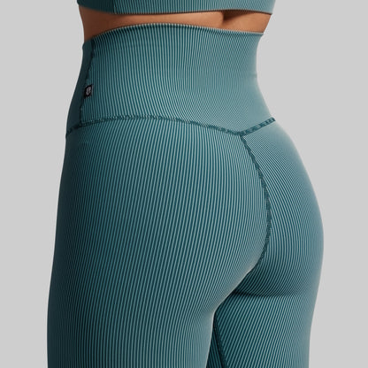 Teal ribbed leggings on a gray background