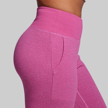 Close-up of pink textured leggings on a plain background