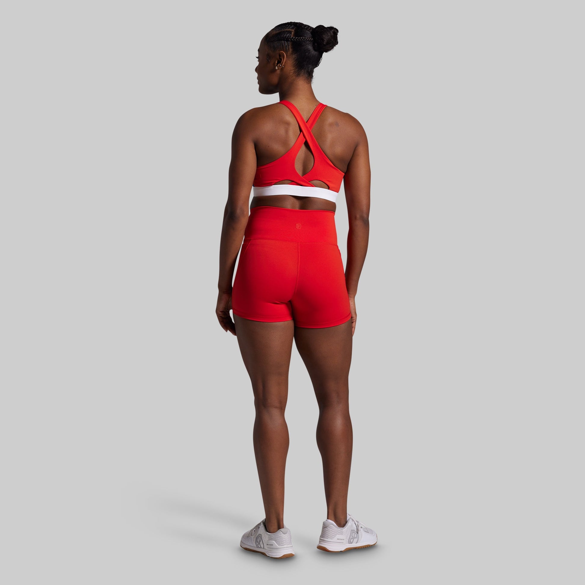 Person wearing a red athletic outfit on a gray background