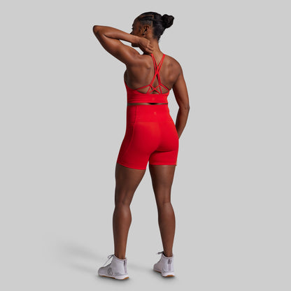 Person wearing a red athletic outfit on a gray background