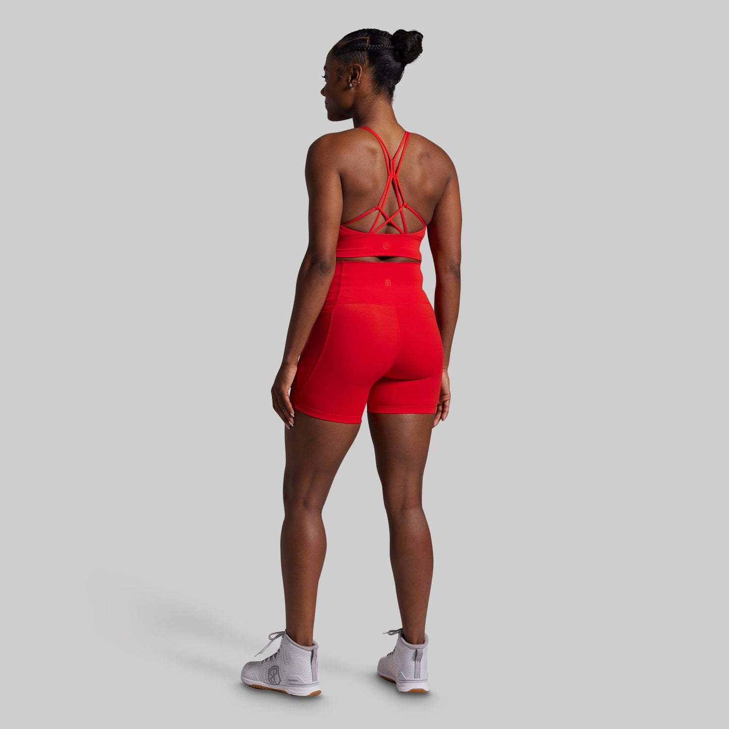 Person wearing a red athletic outfit on a gray background