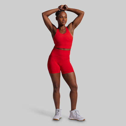 Person wearing a red athletic outfit on a gray background