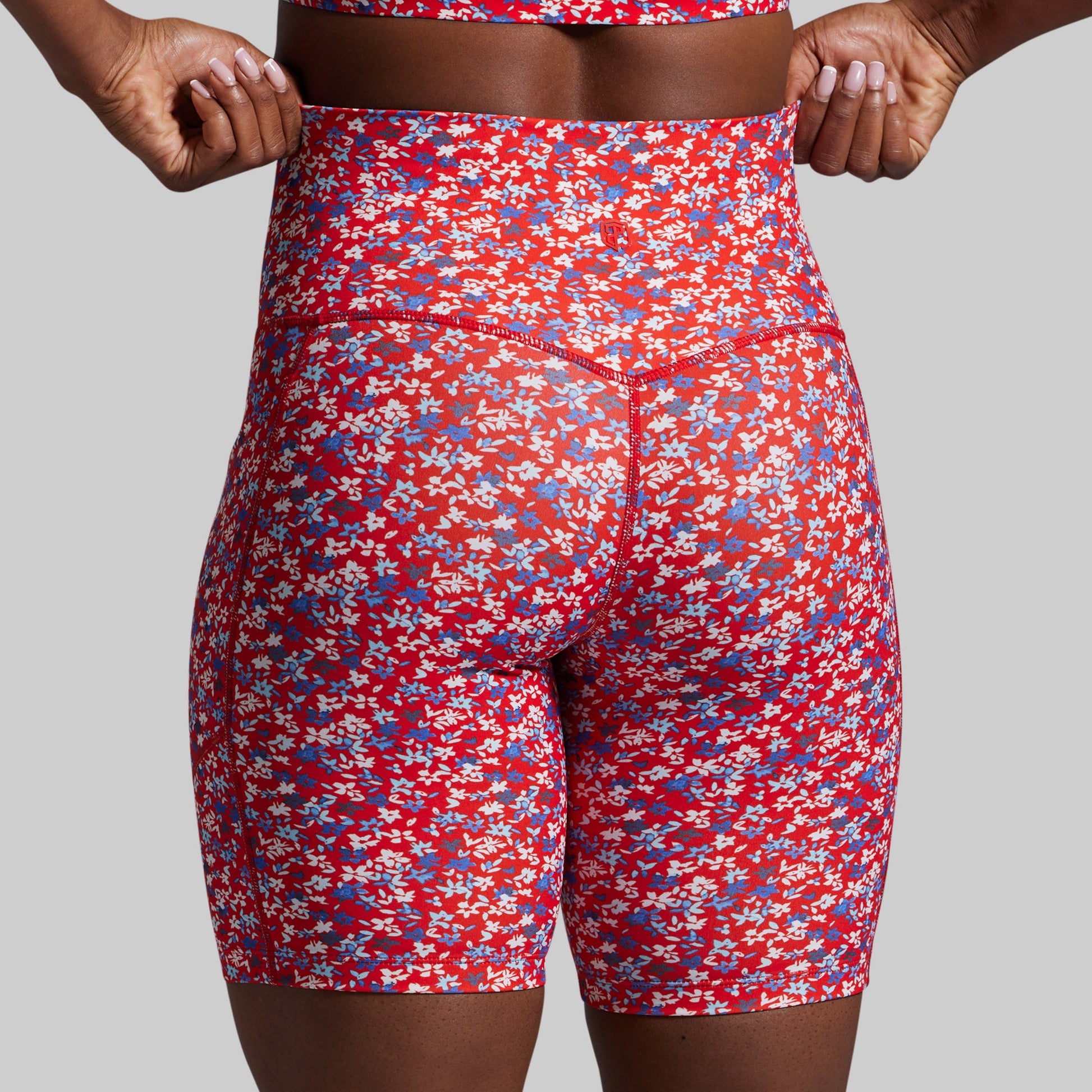 Red floral patterned shorts on a plain background