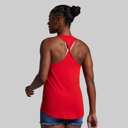 Person wearing a red tank top on a gray background