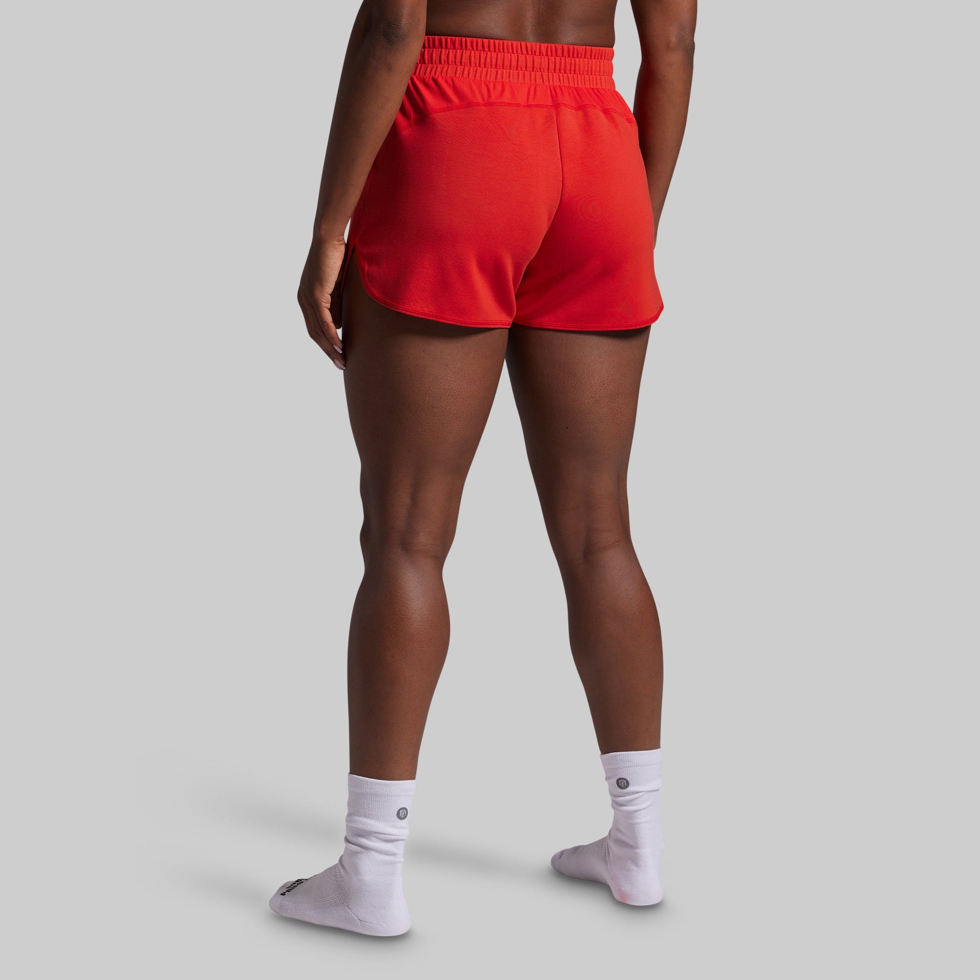 Person wearing red shorts on a gray background