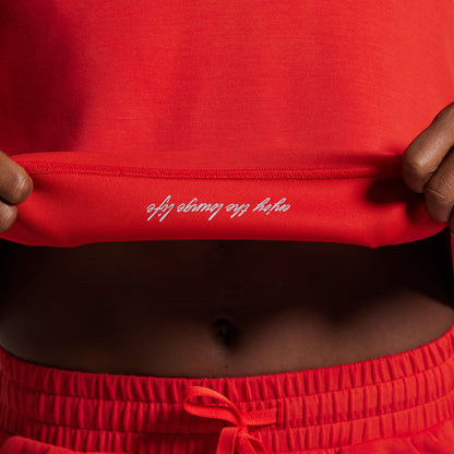Red athletic outfit with white text on waistband