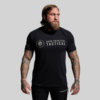 Man wearing a black t-shirt with 'Born Primitive Tactical' logo on a gray background