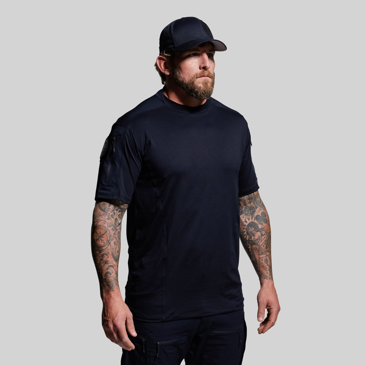 Man wearing a blue t-shirt and cap on a gray background